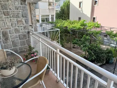 a balcony with a table and chairs and plants at Apartment deluxe Ina FREE PARKING in Budva