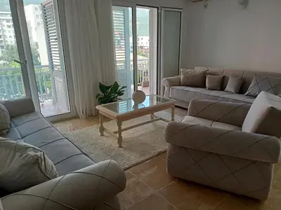 a living room with couches and a coffee table at Apartment deluxe Ina FREE PARKING in Budva
