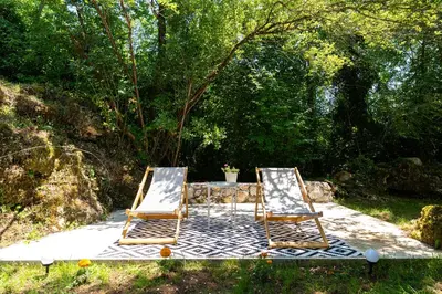 two chairs and a table in the grass at NAJ village in Cetinje