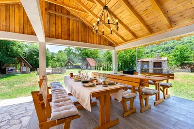 an outdoor dining room with a table and chairs at NAJ village in Cetinje