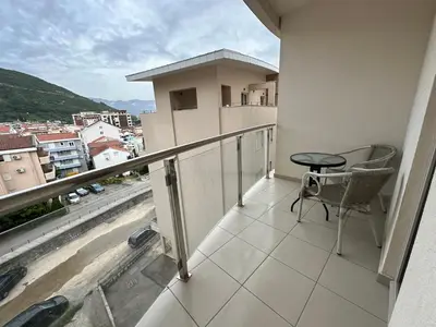a balcony with a table and a view of a city at Jovana Apartments 2 in Budva