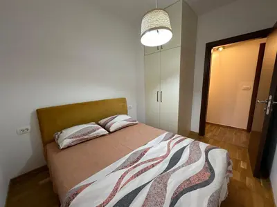 a bedroom with a bed with two pillows on it at Jovana Apartments 2 in Budva