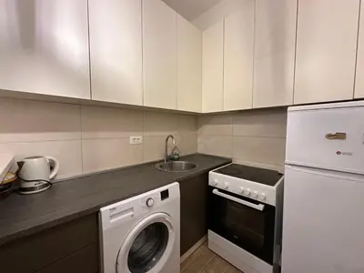 a kitchen with a washing machine and a sink at Jovana Apartments 2 in Budva