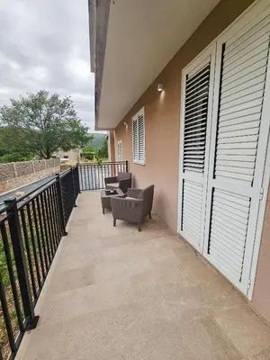 a balcony with two chairs and a railing at Boulevard Apartments in Kotor