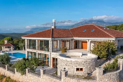 an aerial view of a house with a swimming pool at Villa Carevic with Indoor & Outdoor Pool in Kotor