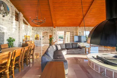 a living room with a couch and a table at Villa Carevic with Indoor & Outdoor Pool in Kotor