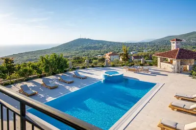 a villa with a swimming pool and views of the ocean at Villa Carevic with Indoor & Outdoor Pool in Kotor