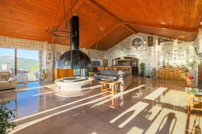 a large living room with a couch and a table at Villa Carevic with Indoor & Outdoor Pool in Kotor