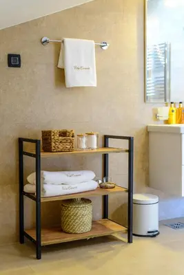 a shelf in a bathroom with towels on a wall at Villa Carevic with Indoor & Outdoor Pool in Kotor
