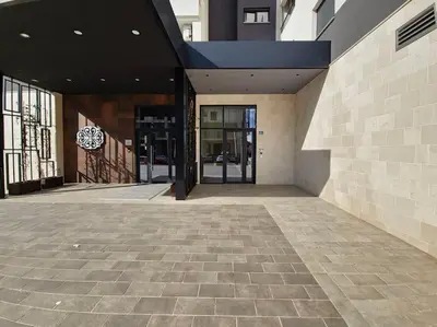 an empty building with a lobby with a glass door at The Serendipity in Podgorica