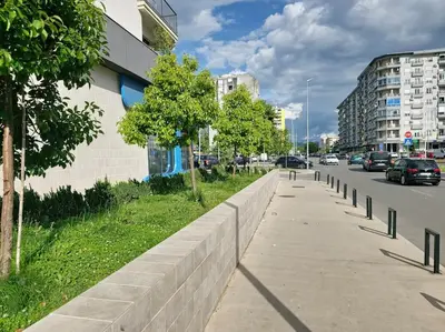 a sidewalk next to a street with cars on the road at The Serendipity in Podgorica