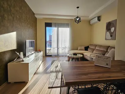 a living room with a couch and a table at The Serendipity in Podgorica