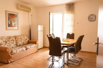 a living room with a table and a couch at Solaris Summer Resort Apartments in Sutomore