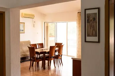 a dining room with a table and chairs at Solaris Summer Resort Apartments in Sutomore
