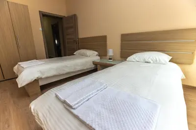a hotel room with two beds and a mirror at Apartmani Bulevar in Cetinje