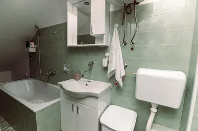 a bathroom with a sink and a toilet and a tub at Apartmani Bulevar in Cetinje