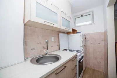 a kitchen with a sink and a stove at Pizana Budva Central in Budva