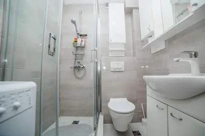 a bathroom with a shower and a toilet and a sink at Pizana Budva Central in Budva