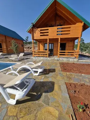 a group of lounge chairs in front of a house at Bungalovi Spahic in Ulcinj
