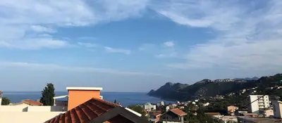 a view of a city with the ocean in the background at Арartment IRENA in Dobra Voda