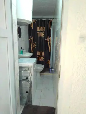 a bathroom with two sinks and a shower curtain at Luiggi in Kotor