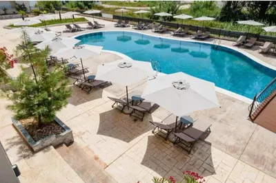 an overhead view of a pool with umbrellas and chairs at Apartment AS in Ulcinj