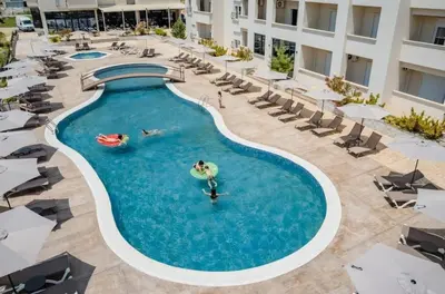 a pool at a hotel with people swimming in it at Apartment AS in Ulcinj