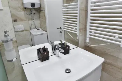 a white bathroom with a sink and a mirror at PREMIUM Tre canne apart 