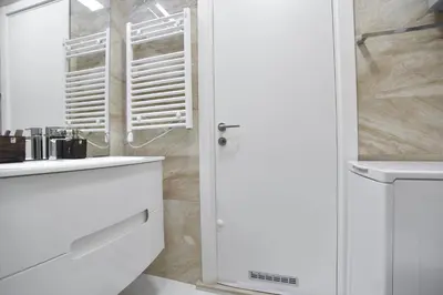 a white bathroom with a sink and a mirror at PREMIUM Tre canne apart 