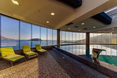 a room with two chairs and a swimming pool at PREMIUM Tre canne apart 