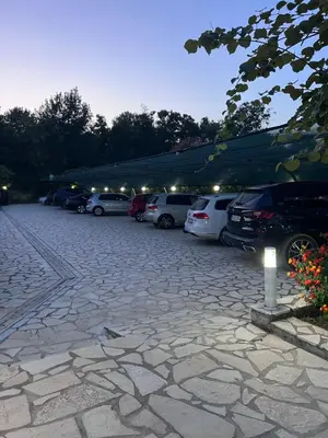 a parking lot with a bunch of cars parked at Residence LEORA in Ulcinj