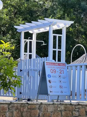 a blue gate with a sign in front of it at Residence LEORA in Ulcinj