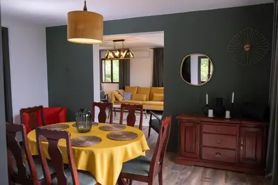 a dining room with a table and a living room at Villa Concordia in Budva