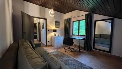 a living room with a couch and a desk at Villa Concordia in Budva