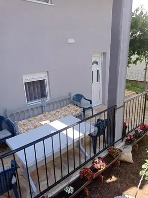 a balcony with a table and chairs and a window at Olga 112 in Bar