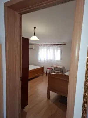 a room with a bedroom and a bed and a table at Aleksandrija in Čanj