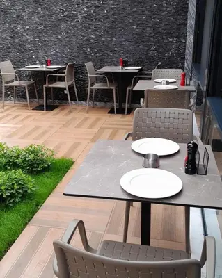 a group of tables and chairs on a patio at Viola Hotel Budva in Budva