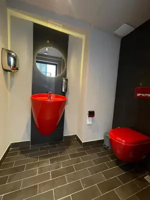a bathroom with a red tub and a red toilet at Viola Hotel Budva in Budva