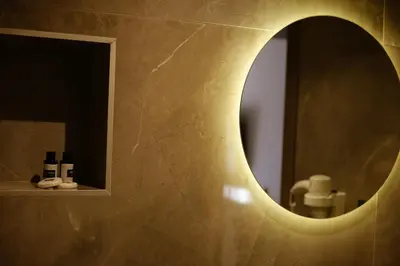 a bathroom with a mirror and a sink at Viola Hotel Budva in Budva