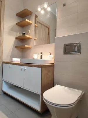 a bathroom with a white toilet and a sink at Kan in Podgorica