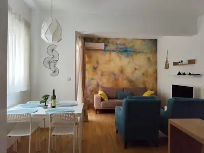 a living room with a table and a couch at Kan in Podgorica