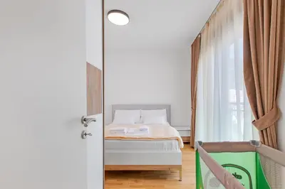 a bedroom with a bed and a window at ID LUX APARTMENTS in Becici