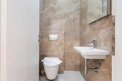 a bathroom with a toilet and a sink at ID LUX APARTMENTS in Becici