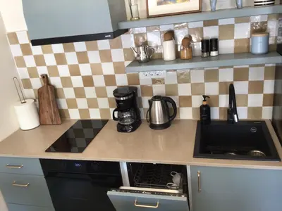 a kitchen counter with a stove and a sink at Private Patio Przno Steps to Beach 2 Bedroom 2 Parkings BBQ Villa Olive in Sveti Stefan