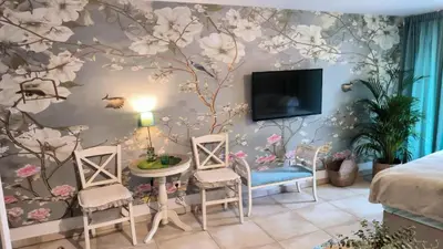 a bedroom with a wall mural of flowers at Centre Budva Blue in Budva