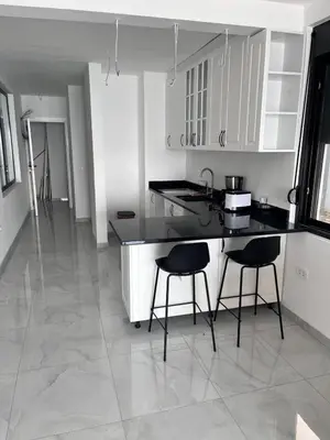a kitchen with a counter and two stools in it at ALOHA Beach front Vacation Rental in Ulcinj
