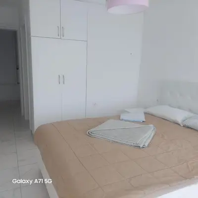 a bed with a blanket on it in a room at ALOHA Beach front Vacation Rental in Ulcinj
