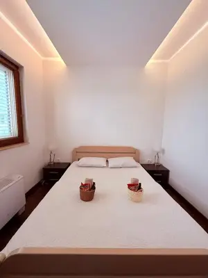 a bedroom with a bed with two baskets on it at The Budva Apartment in Budva
