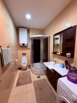 a bathroom with a shower and a toilet and a sink at The Budva Apartment in Budva
