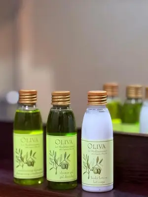 three bottles of olive oil and vinegar sitting on a table at The Budva Apartment in Budva